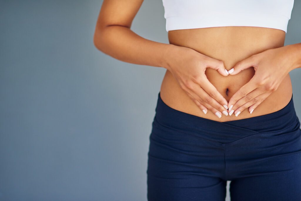 Woman with her hands over her abdomen