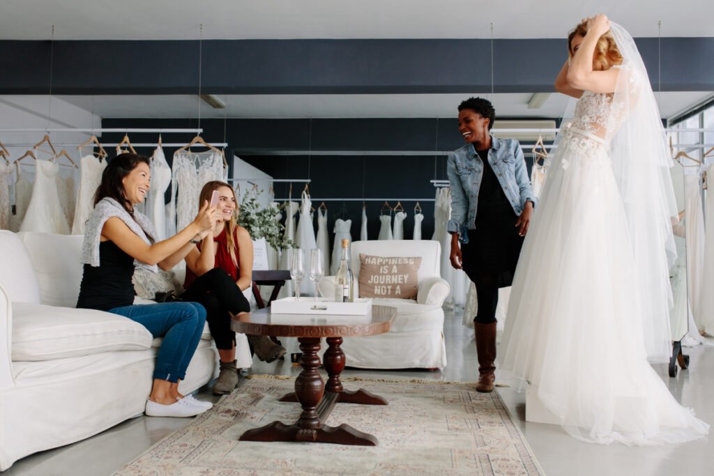 Boston bride-to-be trying on wedding dresses at a bridal shop with her friends