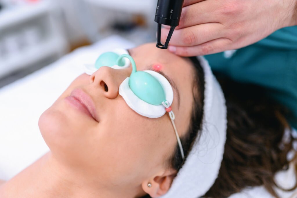 Woman getting a laser treatment from a qualified laser technician