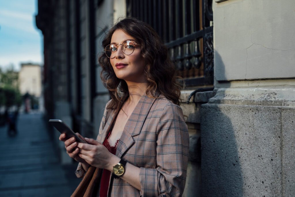 Woman posing with her phone in a historic city
