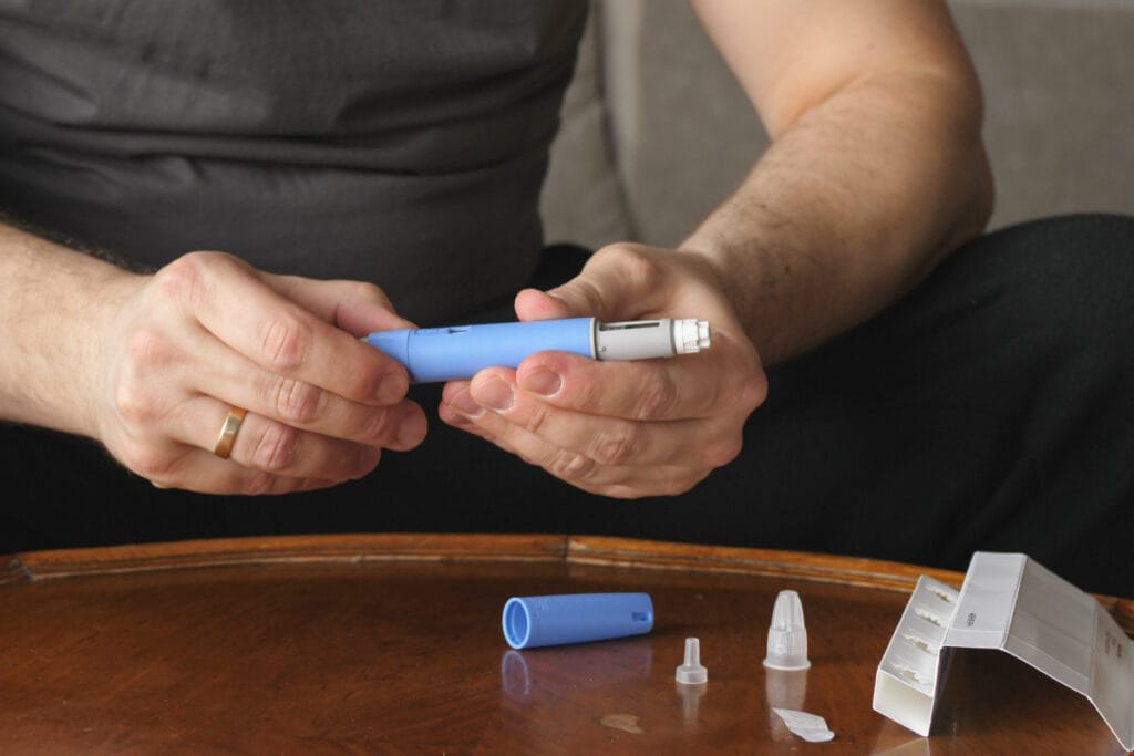 Man opening semaglutide weight loss injections cartridge and instructions 