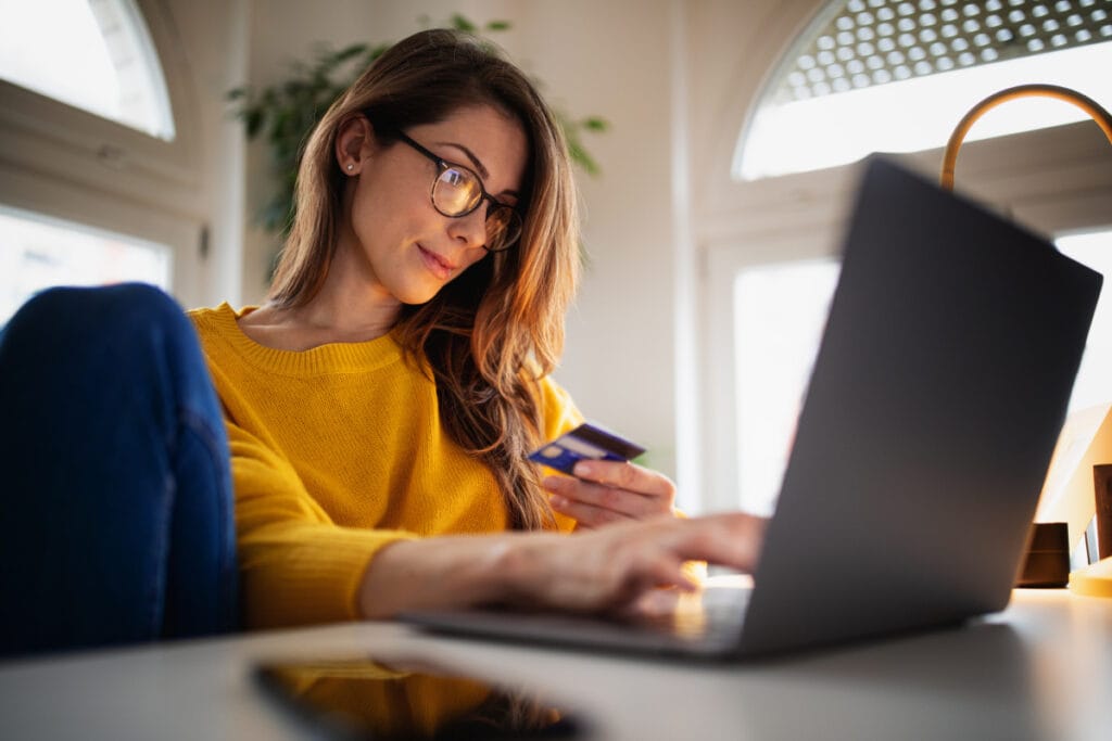 Woman using credit card and applying for Boston plastic surgery financing 